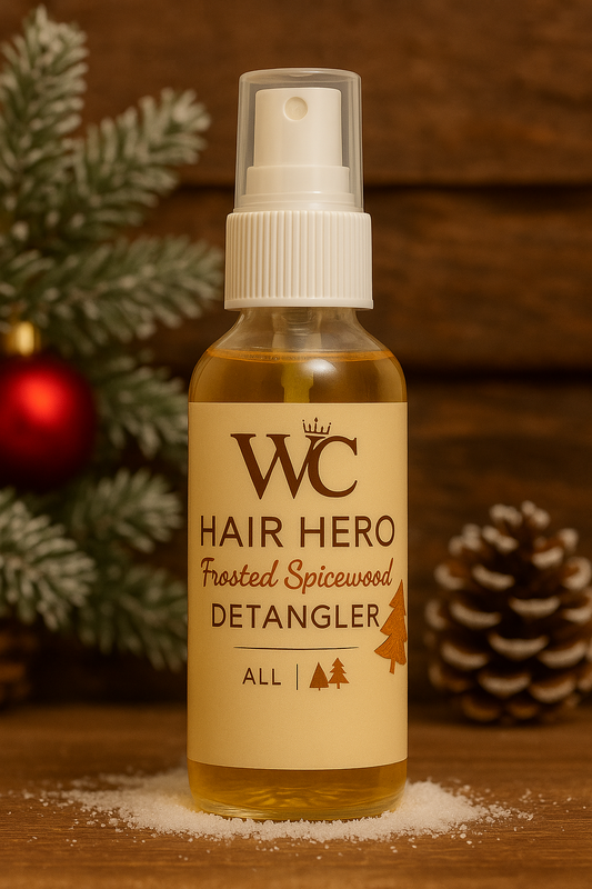 A bottle of WC Hair Hero Organic Detangler placed on a rustic winter cabin background with snow, warm wooden textures, and subtle holiday lighting.